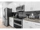 Kitchen featuring stainless steel appliances and gray backsplash at 4375 Scene Ln, Kissimmee, FL 34746