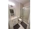 Compact bathroom featuring a single vanity, toilet, and a shower with glass doors for a modern, efficient design at 4412 Conroy Club Dr, Orlando, FL 32835