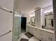 Bathroom featuring glass shower, double vanity, and cabinets at 4412 Conroy Club Dr, Orlando, FL 32835