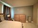 Bedroom featuring matching wooden dressers, a soft bedspread, and decorative curtains at 4412 Conroy Club Dr, Orlando, FL 32835