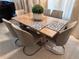 Bright dining area with seating for six, complemented by a glass-topped table and stylish place settings at 4412 Conroy Club Dr, Orlando, FL 32835