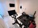 Bright exercise room featuring modern equipment including a Peloton bike, free weights and ample floor space at 4412 Conroy Club Dr, Orlando, FL 32835