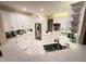 Modern kitchen featuring white cabinets, a marble countertop, and stainless steel appliances at 4412 Conroy Club Dr, Orlando, FL 32835