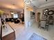 Open-concept living and dining area with stylish decor, elegant chandeliers, and bright, neutral colors at 4412 Conroy Club Dr, Orlando, FL 32835