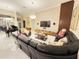 Large living room with plush leather seating, modern decor, and stylish lighting fixtures at 4412 Conroy Club Dr, Orlando, FL 32835