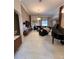 Spacious living area with tile flooring, a piano, and modern entertainment setup at 4412 Conroy Club Dr, Orlando, FL 32835