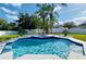 Inviting backyard pool with lush tropical landscaping and a serene blue water finish, perfect for relaxation at 4412 Conroy Club Dr, Orlando, FL 32835