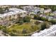 Aerial view features green park area, palms, apartments and colorful townhomes at 4608 Atwood Dr, Orlando, FL 32828