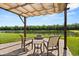 Serene backyard with cozy pergola, chairs, and fire pit, perfect for enjoying outdoor evenings by the lake at 4608 Atwood Dr, Orlando, FL 32828