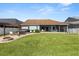 Expansive backyard with patio, hot tub, fire pit, and well-manicured lawn, creating an ideal outdoor living space at 4608 Atwood Dr, Orlando, FL 32828