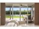 Patio view with outdoor seating overlooking the green yard and scenic lake at 4608 Atwood Dr, Orlando, FL 32828
