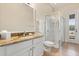 Bright bathroom with a glass-enclosed shower, granite countertops, and white cabinets at 4608 Atwood Dr, Orlando, FL 32828