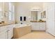 Spacious bathroom boasting dual vanities, garden tub, and natural light from a window at 4608 Atwood Dr, Orlando, FL 32828