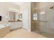 Elegant bathroom featuring a glass shower, marble counters, and a separate soaking tub at 4608 Atwood Dr, Orlando, FL 32828