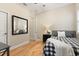 Cozy bedroom featuring hardwood floors, a ceiling fan, and a large mirror reflecting the room at 4608 Atwood Dr, Orlando, FL 32828