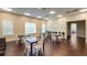 Well-lit common area with tables, chairs, and views of clocks and a separate seating area at 4608 Atwood Dr, Orlando, FL 32828