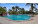 A spacious community pool is surrounded by tropical landscaping and brick pavers at 4608 Atwood Dr, Orlando, FL 32828