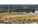 Scenic view of community amenities, including green spaces, a pond, and palm tree lined street at 4608 Atwood Dr, Orlando, FL 32828