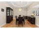 Elegant dining room with hardwood floors, a decorative chandelier, and a display cabinet at 4608 Atwood Dr, Orlando, FL 32828