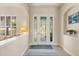 Bright foyer featuring a decorative glass front door and neutral decor at 4608 Atwood Dr, Orlando, FL 32828