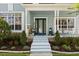 Inviting front porch with blue door, columns, and manicured landscaping at 4608 Atwood Dr, Orlando, FL 32828
