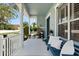 Inviting front porch with bench seating, columns, and white railing at 4608 Atwood Dr, Orlando, FL 32828
