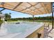 Lakeside hot tub under a pergola, providing a relaxing retreat with scenic water views and a tranquil ambiance at 4608 Atwood Dr, Orlando, FL 32828
