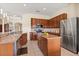 Spacious kitchen featuring wood cabinets, stainless steel appliances, and an island with granite countertops at 4608 Atwood Dr, Orlando, FL 32828