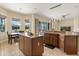 Open kitchen featuring wood cabinets, tile floors, granite counters, and an island with a breakfast bar at 4608 Atwood Dr, Orlando, FL 32828