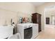 Functional laundry room with washer, dryer, utility sink, and storage shelves at 4608 Atwood Dr, Orlando, FL 32828