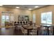 Comfortable lounge area with tables, chairs, and natural lighting from large windows at 4608 Atwood Dr, Orlando, FL 32828