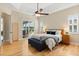 Bright main bedroom with hardwood floors, ceiling fan, and sliding glass doors to a patio at 4608 Atwood Dr, Orlando, FL 32828