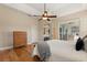Bedroom featuring wood floors, tray ceiling, ceiling fan, and a sliding glass door leading outside at 4608 Atwood Dr, Orlando, FL 32828