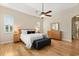 Serene bedroom with tray ceiling, hardwood floors, plantation shutters, and a ceiling fan at 4608 Atwood Dr, Orlando, FL 32828