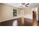 The bedroom has hardwood floors, a ceiling fan, and bright light at 4772 Lake Ridge Rd # 66, Orlando, FL 32808