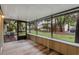 View from inside a screened porch that overlooks lawn with mature trees at 4772 Lake Ridge Rd # 66, Orlando, FL 32808