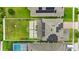 Overhead view of home showing solar panels, an ample backyard, and nearby pool with a screened enclosure at 4783 Riverwalk Dr, St Cloud, FL 34771