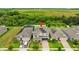 Aerial view of home featuring solar panels, a lush lawn, and a brick driveway at 4783 Riverwalk Dr, St Cloud, FL 34771