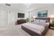 Primary bedroom with neutral carpet, a chandelier, and a modern style at 4783 Riverwalk Dr, St Cloud, FL 34771