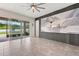 A spacious living room with tile floors, large sliding doors, and a decorative wall accent at 4783 Riverwalk Dr, St Cloud, FL 34771
