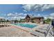 A community pool with lounge chairs and shaded seating areas on a sunny day at 4783 Riverwalk Dr, St Cloud, FL 34771