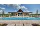 Resort-style community pool area with a covered pavilion, tables, chairs, and lounge seating at 4783 Riverwalk Dr, St Cloud, FL 34771
