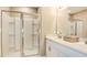 Bright bathroom with white cabinets, a glass-door shower, and double sinks at 531 Wayland Dr, Haines City, FL 33844
