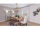 Bright dining room with stylish decor, a modern chandelier, and seating for six at 531 Wayland Dr, Haines City, FL 33844