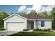Charming single-story home featuring a two-car garage, neutral paint, and a well-maintained lawn at 531 Wayland Dr, Haines City, FL 33844