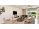 Cozy living room with neutral tones, stylish furnishings, and a view of the outdoors at 531 Wayland Dr, Haines City, FL 33844