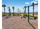 A community playground with swings, climbing area, and seating on a sunny day at 531 Wayland Dr, Haines City, FL 33844