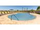 Sparkling pool with comfortable lounge chairs and umbrellas for ultimate relaxation at 531 Wayland Dr, Haines City, FL 33844