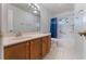 Bathroom featuring a wooden vanity, large mirror, and tiled floor and shower at 622 Tomlinson Ter, Lake Mary, FL 32746