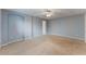 Large bedroom features a neutral carpet, ceiling fan, and soft blue walls at 622 Tomlinson Ter, Lake Mary, FL 32746